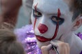 Street makeup. The image of a clown or mime. Costume for carnival or holiday halloween. Cosplay at a horror party. Artist`s hand Royalty Free Stock Photo