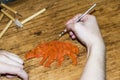 Artist`s Hands cut and modeling of animal figures of clay and pl