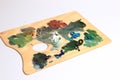 The artist`s palette. Close-up Of An Art Palette Top view of a colorful palette with colorful mixed colors. oil paints Royalty Free Stock Photo