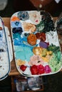 Artist`s palette with colorful acrylic and oil paints, paint brushes and pencils Royalty Free Stock Photo