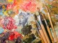 Art paints and brushes lie on the artist`s wooden palette Royalty Free Stock Photo