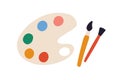 Artist's palette with paints of different colors and brushes or paintbrushes. Top view of painter's tools isolated on Royalty Free Stock Photo