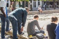 Artist sketches with onlookers in a Paris square