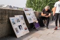 Artist sketches and sells his pictures along the Seine on a Sunday morning, Paris, France