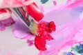 The artist squeezed the paint onto the palette and mixes the pink paint with a synthetic brush Royalty Free Stock Photo