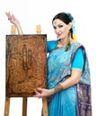 Artist standing at the easel with pyrography painting Eternal Ha