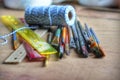 Artist supplies of brushes, rulers, and twine.