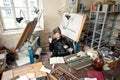 Artist in untidy studio