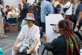 Artist using pencil drawing picture of a man