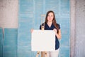 Artist with white canva in her studio