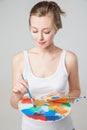 Artist woman with paint palette. Isolated. Royalty Free Stock Photo