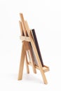 Artist wooden easel with canvas isolated on white