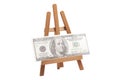 Artist wooden easel with one hundred dollars isolated on white Royalty Free Stock Photo