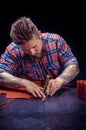 Artist working with leather creating leatherwork Royalty Free Stock Photo