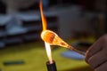 Artist works on glass with fire