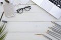 Artist workspace with laptop, glasses, colored pencils and white earplugs . Hand lettering inspiration quote. Hipster