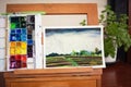 Artist's studio with easel and box of watercolor paints near rice terrace landscape on cotton paper. Watercolour Royalty Free Stock Photo