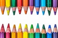 Artistic arrangement crayons form a colorful border on a white surface