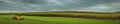 Artistic autumn agricultural landscape. wide panoramic view of a hilly corn field under a cloudy dramatic September sky in stormy