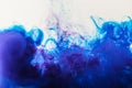 artistic background with blue and purple paint mixing in water