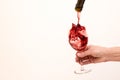 Artistic beautiful picture. Red wine is poured into a glass