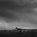 Artistic black and white image of simple house on a hill in Tuscany, Italy