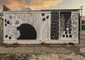 Artistic black and white mural on the outside wall of an Oak Cliff business by Alli, owner of Allikdesign in Dallas, Texas.