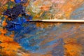 Artistic brush, background image of bright oil-paint palette closeup Royalty Free Stock Photo