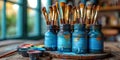 Artistic brushes, palette and tubes with paints, placed on the table, ready for the creative pro Royalty Free Stock Photo