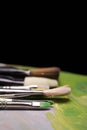 Artistic brushes with traces of paint on a dark background. Back Royalty Free Stock Photo