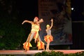 Artistic Colombian dance couple performing on night stage