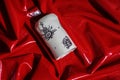 Artistic colored white cup laying on glossy red cloth