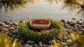 Ceramic bowl on a wreath of pine needles on pebble beach at sunset Royalty Free Stock Photo