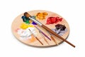 Artistic Creativity Unleashed Wooden Art Palette with Colorful Paint Blobs and Brushes on White Background. created with