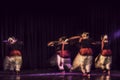 An artistic dancer in a theater shot with a slow shutter speed in order to achieve the desired motion blur