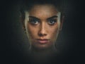 Artistic dark portrait of young woman with beautiful face and eyes