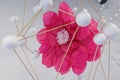 Artistic Depiction of a Pink Flower in Crepe Paper surrounded by a Structure of White Spheres connected Together