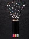 Artistic design and drawing of creative concepts with colored pencils on a black concrete background with a copy of the space Royalty Free Stock Photo