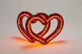 An artistic digital rendition of a neon sign featuring two interlinked hearts, glowing in a deep red hue for Valentine's Day