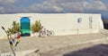 artistic door painted in sea colors, door in Ostuni, turquoise-blue door in a white wall