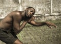 Young attractive contemporary ballet dancer and choreographer , a black African American man dancing and posing on tropical rice Royalty Free Stock Photo