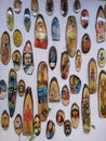 Artistic drawing on wood pieces displayed on a white background for open photography session at Calcutta handicraft trade fair.