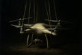 Artistic Drone as a Marionette in muted tones, suspended by strings, symbolizing control or manipulation in technology Royalty Free Stock Photo