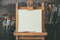 Artistic equipment in a artist studio: empty artist canvas and brushes. Royalty Free Stock Photo