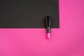 Artistic fashion photo cosmetics product pink lipstick on a black and pink background