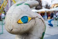 Artistic figure of the Easter Bunny in grey with big blue eyes and yellow, with painted runes and the mysterious marks on the skin