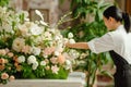 Artistic Florist Perfecting a Luxurious Floral Arrangement. Generative ai