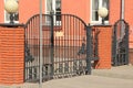 Artistic forging, wrought iron fence and red brick columns with