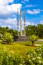 Artistic fountain well with metal figures in tropical setting Mexico