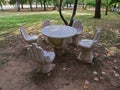Artistic hands shaped concrete garden chairs and table. Royalty Free Stock Photo